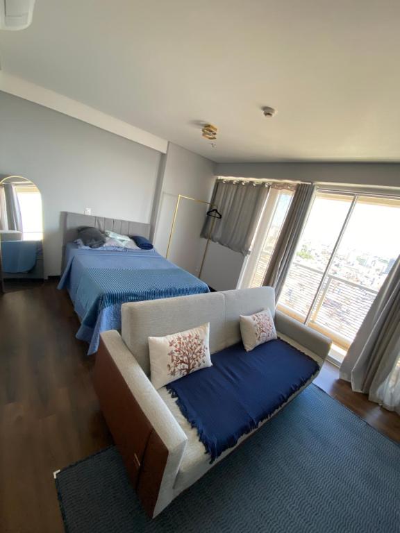 a living room with two beds and a couch at The Cittyplex Osasco - new flat in Osasco