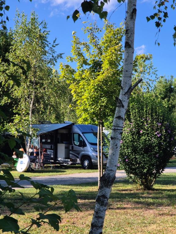 a truck parked in front of a tent in a park at Camping Bela krajina - Pitches in Gradac