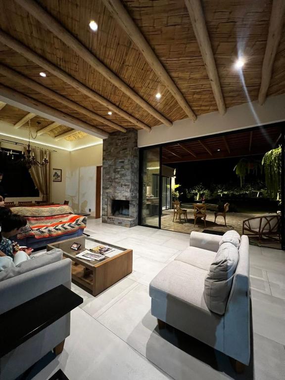 a living room with two couches and a fireplace at Casa de Campo Urpichay in Ricardo Palma