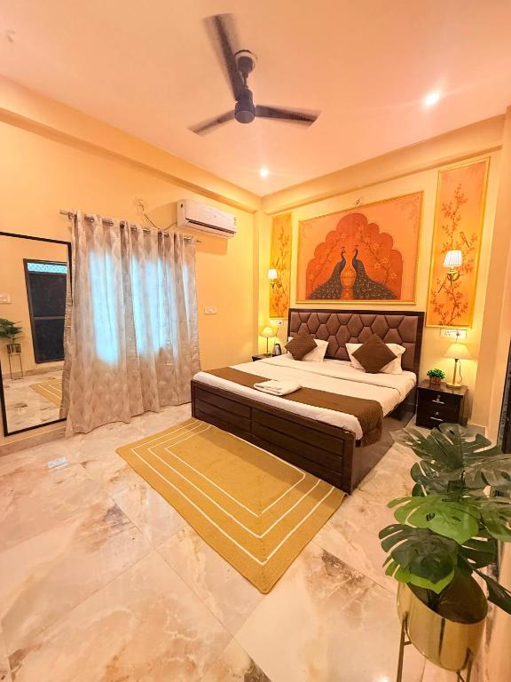 a bedroom with a bed and a ceiling fan at Sukoon e Banaras in Varanasi