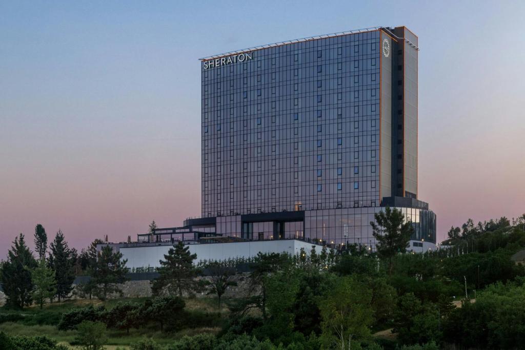 a tall building with a lot of windows at Sheraton Uşak Hotel & Thermal Spa in Uşak