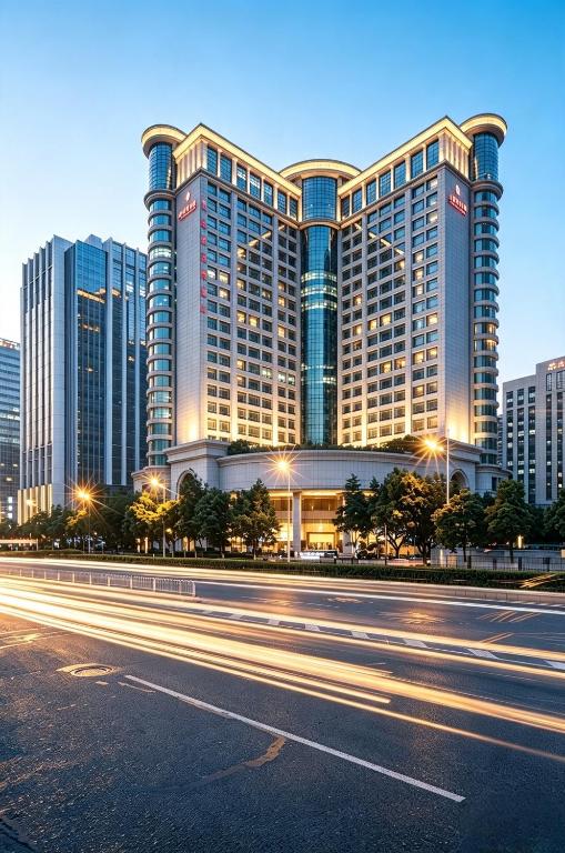 a large building with a street in front of it at Vanburgh Hotel Guangzhou in Guangzhou