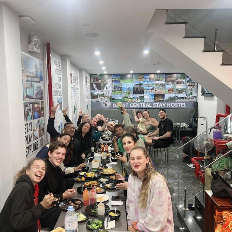 a group of people sitting at a table eating food at Dalat Family Center in Da Lat