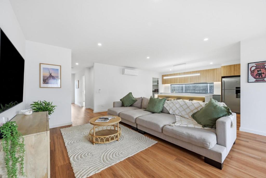 a living room with a couch and a table at Inverloch Seaside Escape in Inverloch