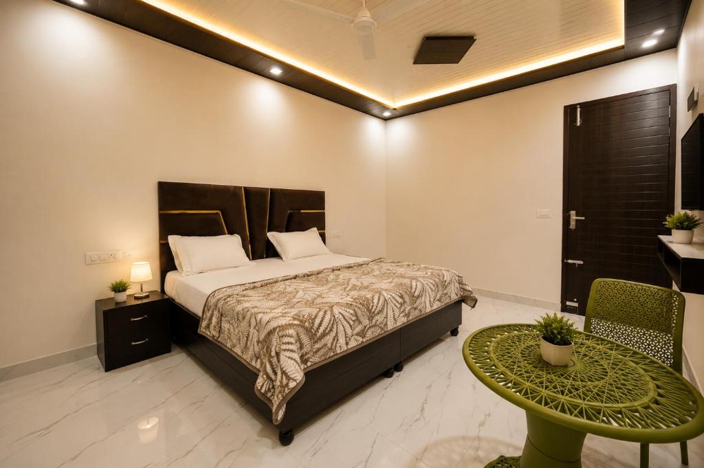 a bedroom with a bed and a table and a chair at Hotel Brothers Elite Stay in Panchkula