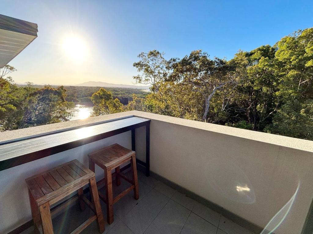 two stools sitting on the balcony of a house at Arizons in South West Rocks