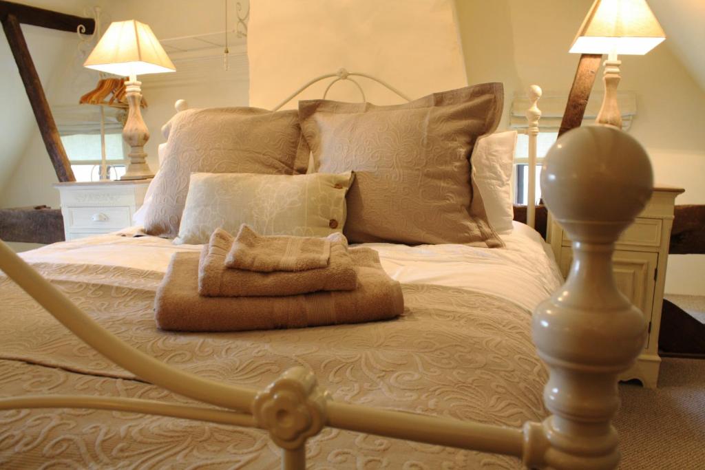 a bedroom with a large bed with two lamps at Riverside House in Norwich