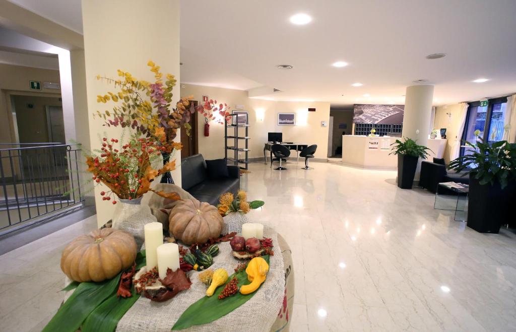 a lobby with pumpkins and candles on a table at Hotel San Rocco in Muggia