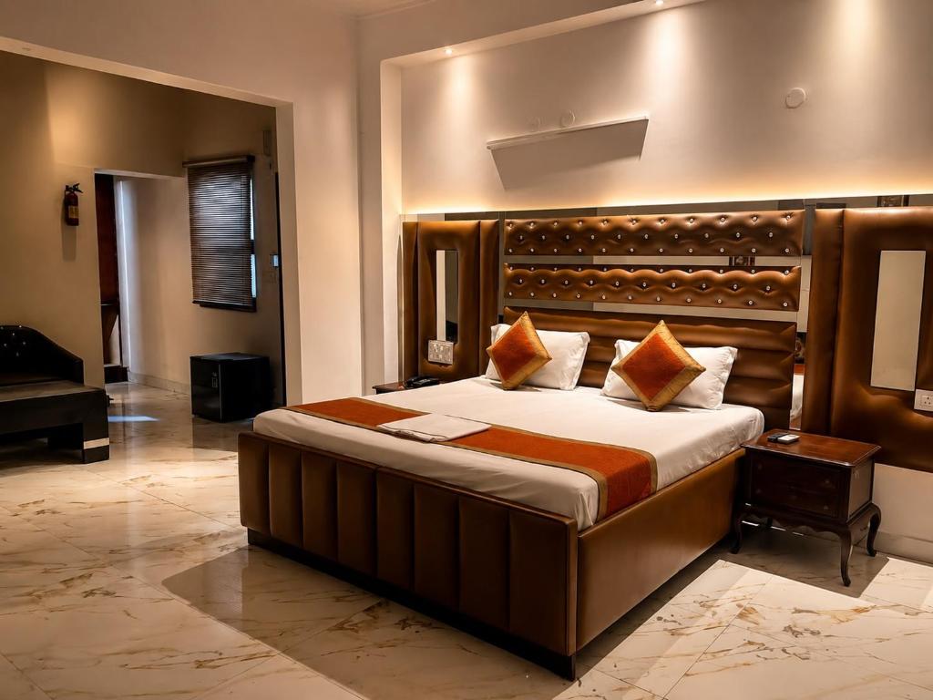 a bedroom with a large bed and a piano at Hotel Swisston Palace in New Delhi