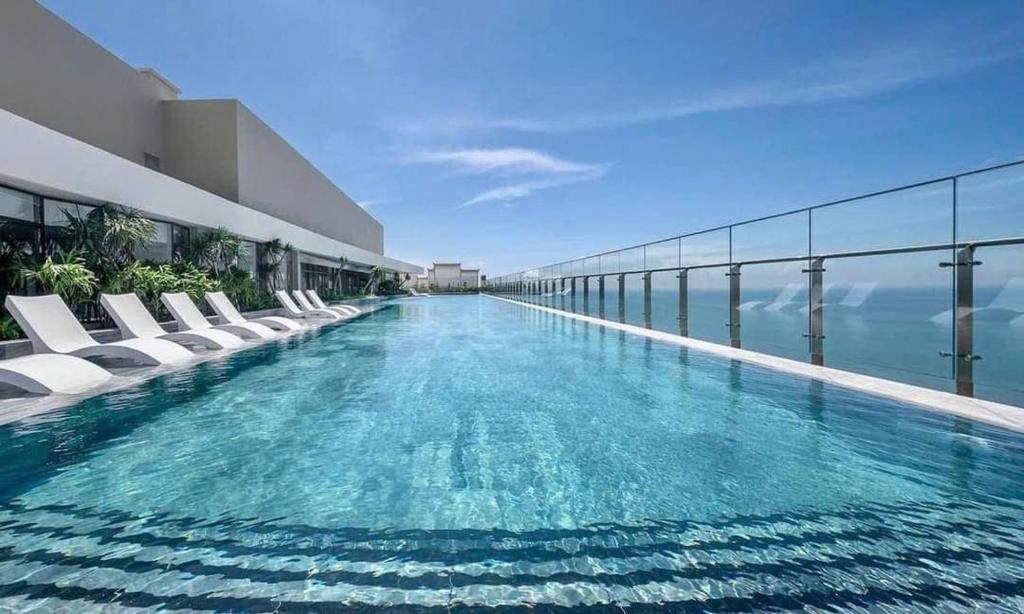a swimming pool on the side of a building at The Song Suites Apartment Vung Tau - Căn Hộ Du Lịch 5 Sao Cạnh Biển in Vung Tau