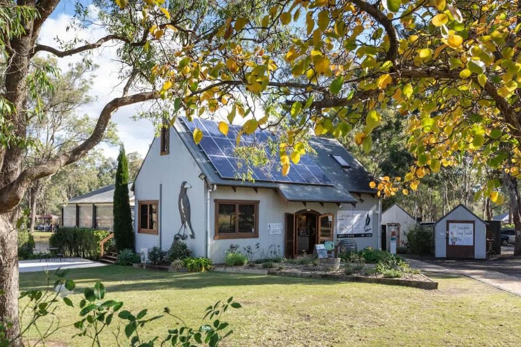 a white house with a solar roof at Gartelmann Studio at Gartelmanns Wines in Rothbury