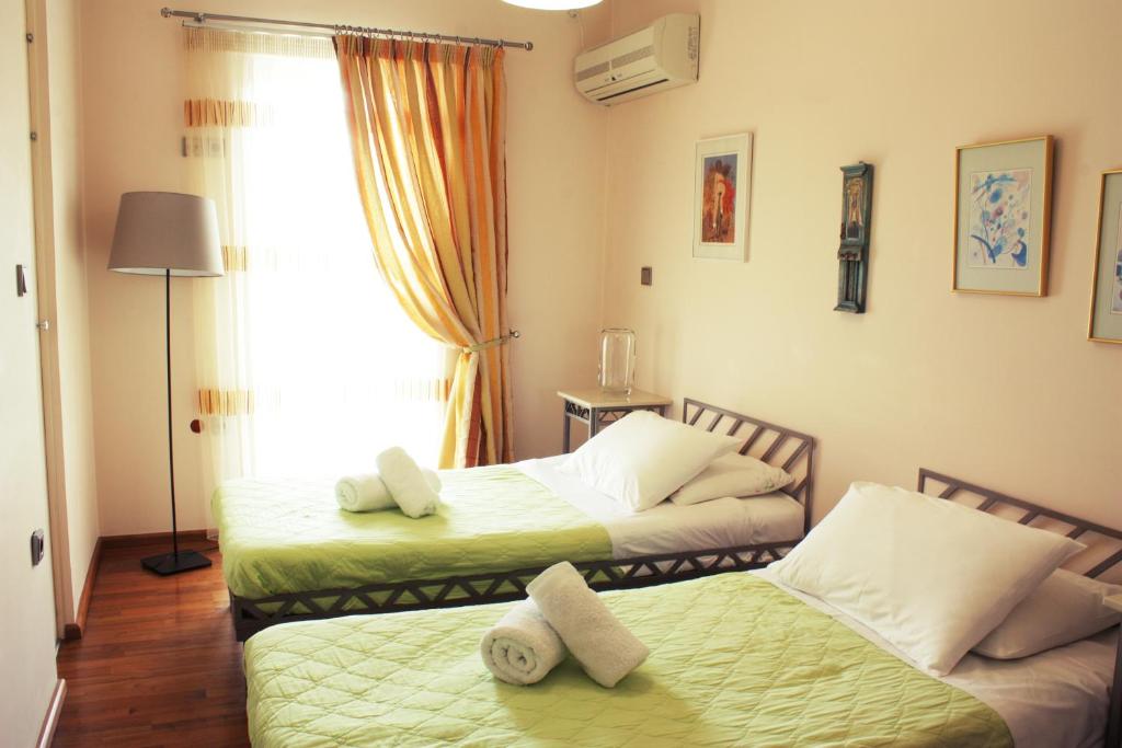 A bed or beds in a room at Veggie Garden Athens B&B
