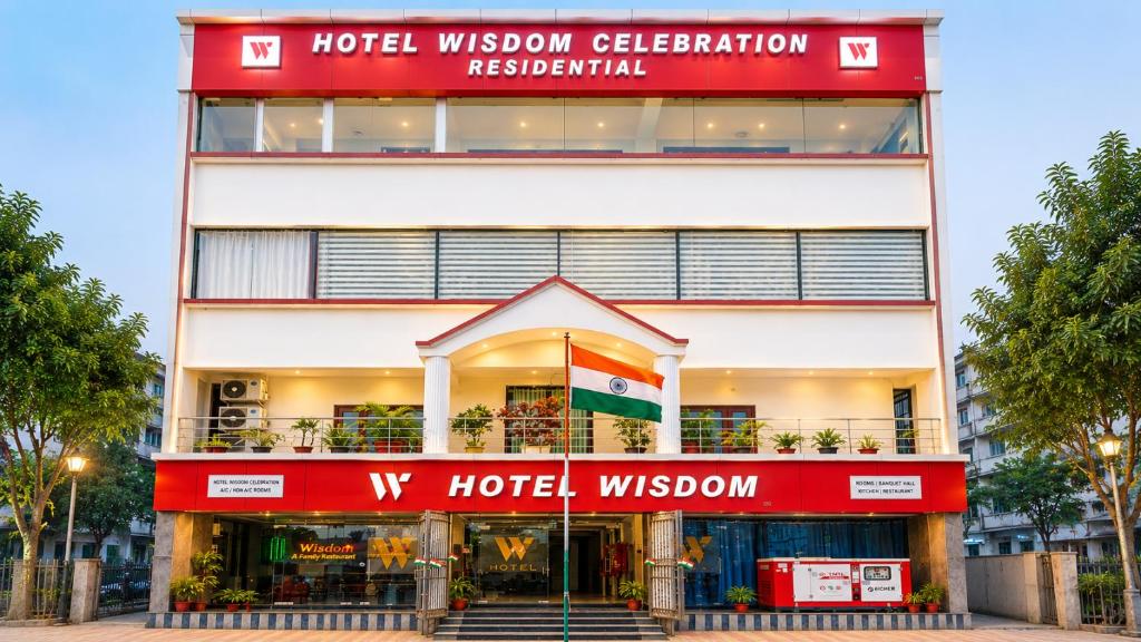 a hotel with a red and white building at hotel wisdom celebration in Motīhāri