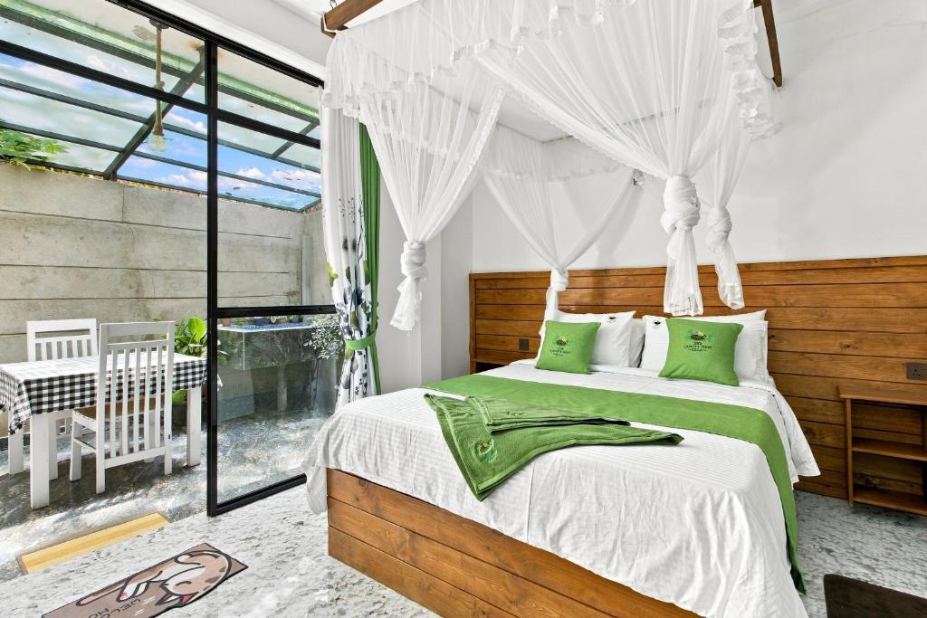 a bedroom with two beds and a window at The Canapy Nest Ella in Ella