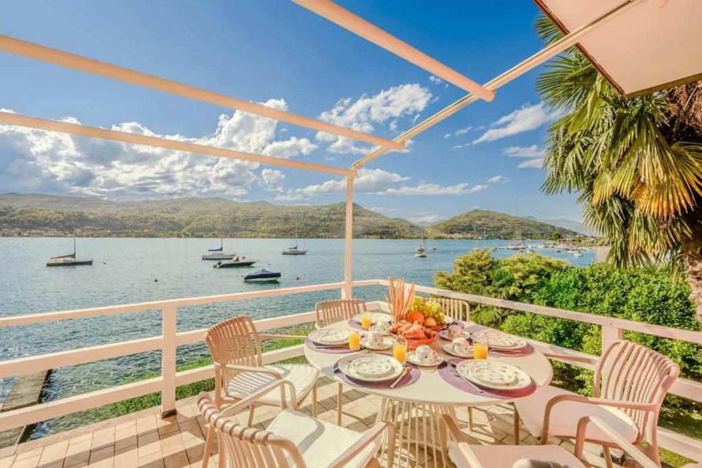 a table on a balcony with a view of the water at Ranco Villa - 14006 in Ranco