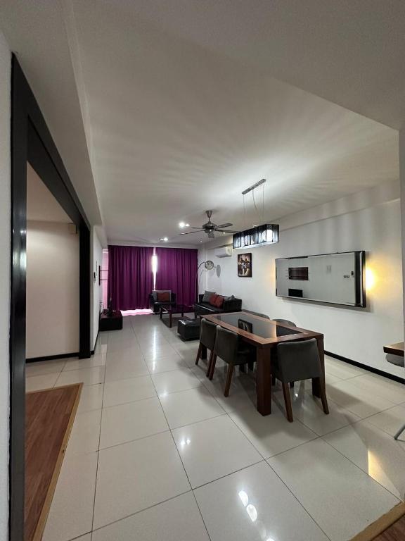 a large living room with a table and chairs at Likas Square - KK Apartment Suite in Kota Kinabalu