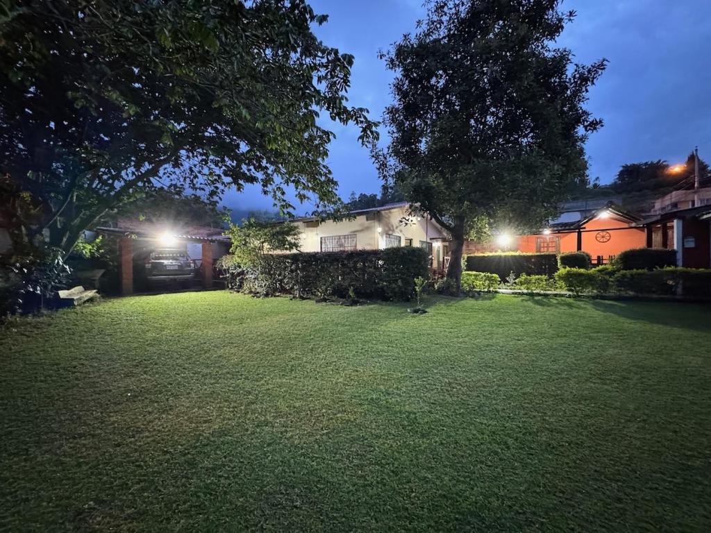 a house with a yard at night with lights at MiniFinquita Ibarra in Ibarra