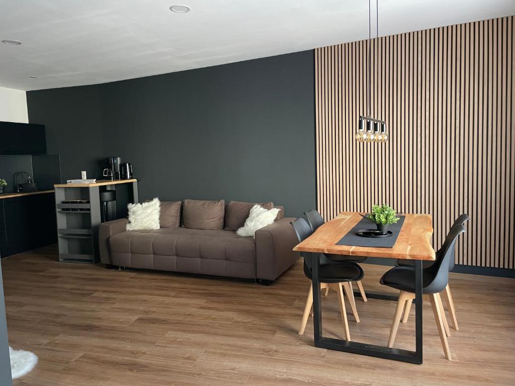 a living room with a couch and a table at Demhouse in Gössenheim