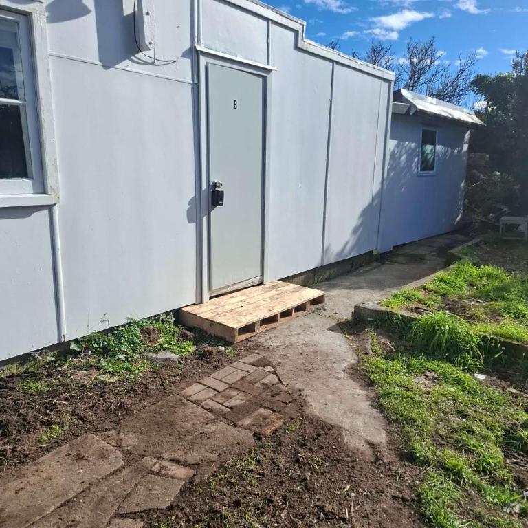 a door to a house with a ramp next to it at 2 Bedroom garden chalet in Rotorua