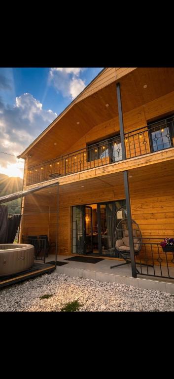 a large wooden building with a balcony on it at Calypso Family Rest House in Hankʼavan
