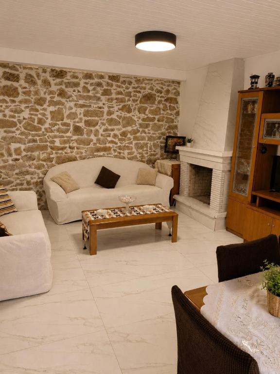 a living room with a couch and a table at Mikel's Village House in Káto Garoúna