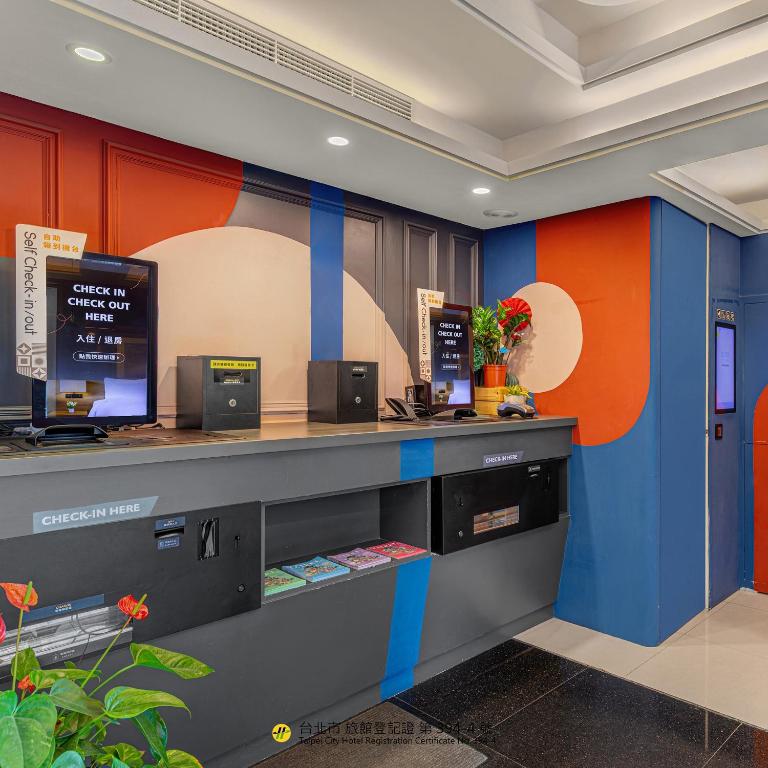 an office with a blue and orange wall at Guide Hotel Taipei Xinyi in Taipei