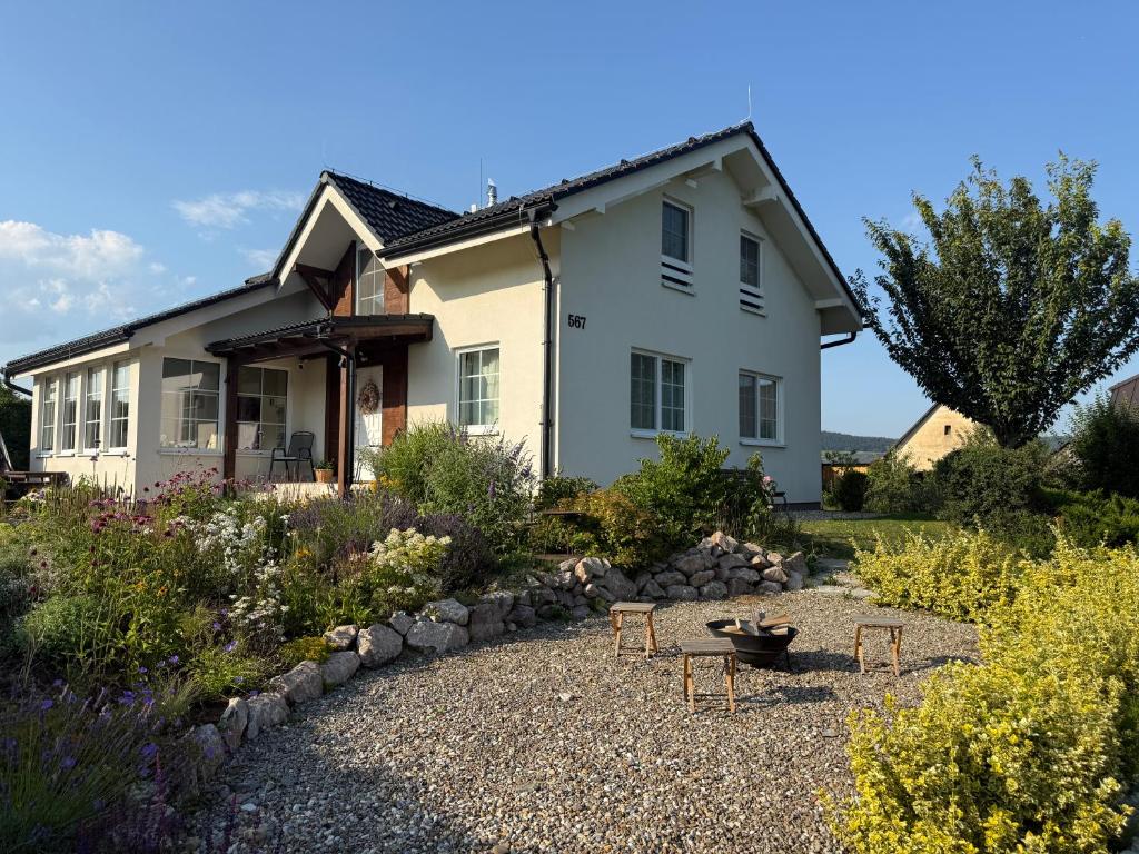 a house with a garden in front of it at Apartment Hydrangea Home in Plavnica