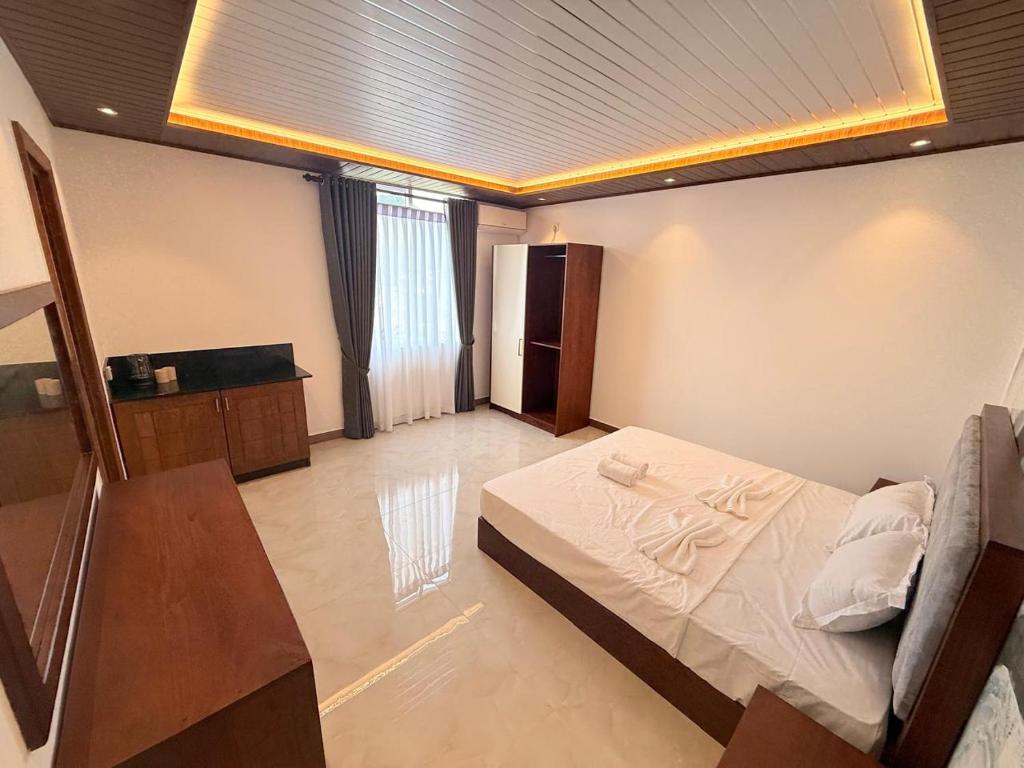 a bedroom with a bed and a table in a room at DBS Villas in Matale