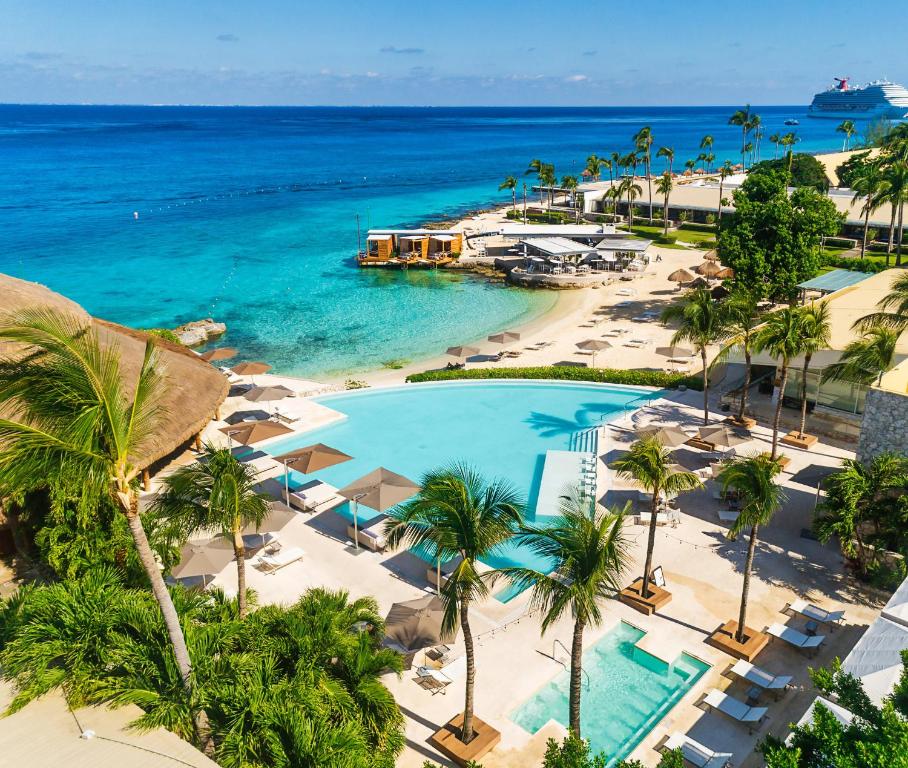 an aerial view of a resort with a pool and the ocean at Presidente InterContinental Cozumel Resort & Spa by IHG in Cozumel