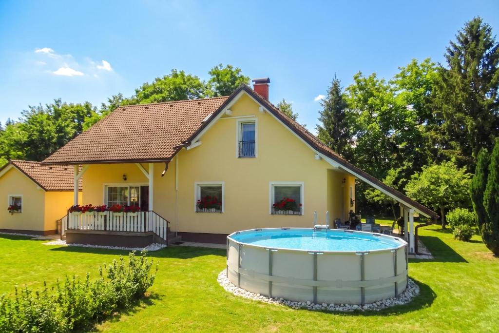 a house with a large pool in the yard at Villa Cujez with Pool & Sauna - Happy Rentals in Rečica ob Savinji