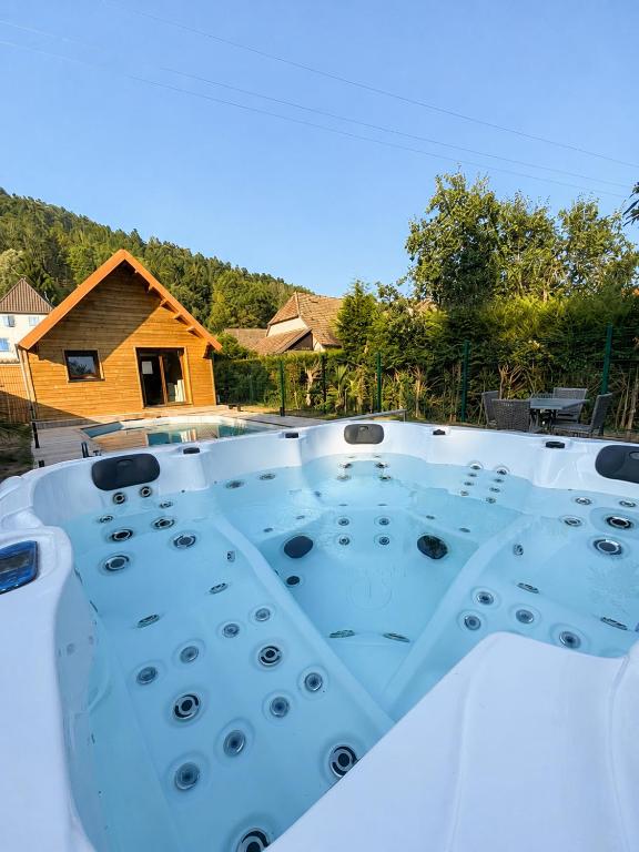 a hot tub in the backyard of a house at Le Chalet Spa Piscine in Rimbach-près-Masevaux