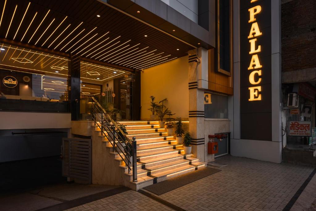 a building with stairs in front of a restaurant at Hotel Maharani Palace in Varanasi