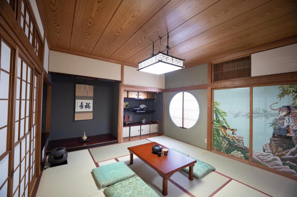 a living room with a wooden ceiling and a table at 縁-en- in Zentsuji