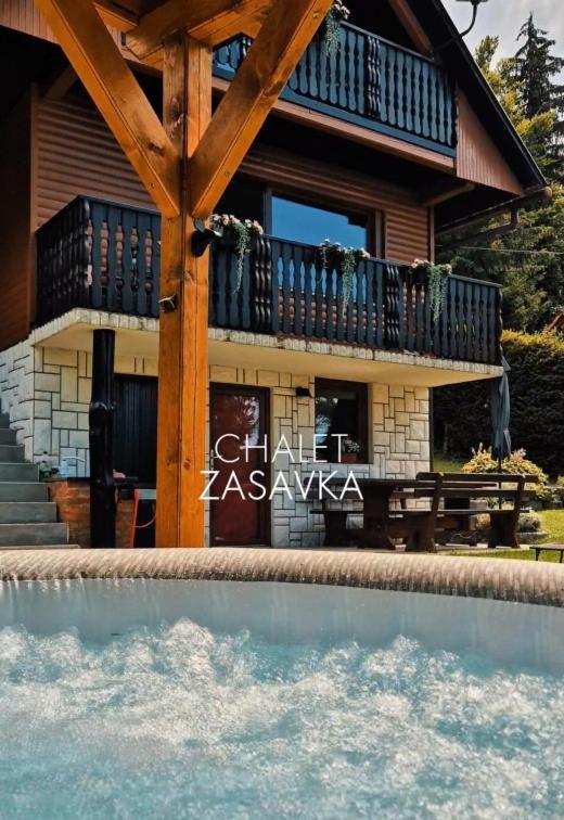 a house with a swimming pool in front of a house at Chalet Zasavka in Dol pri Hrastniku