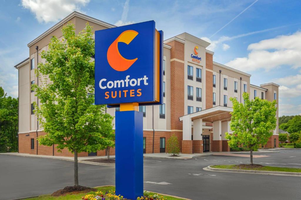a sign in front of a hotel with a comfort suites at Comfort Suites Greensboro-High Point in Greensboro