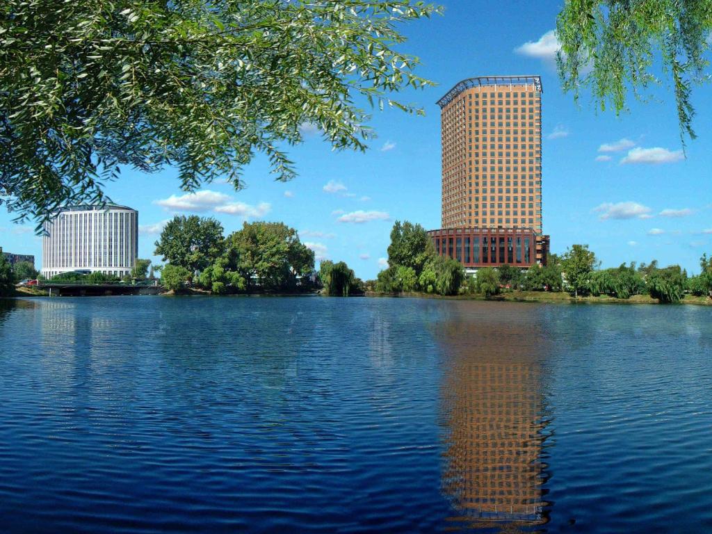 a large body of water with two tall buildings at Swissôtel Shenyang in Shenyang