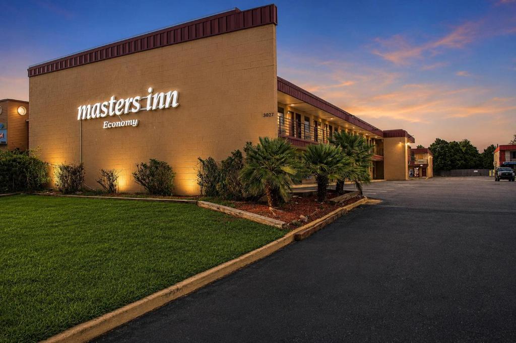 a building with a sign on the side of it at Masters Inn Augusta at Washington Road in Augusta