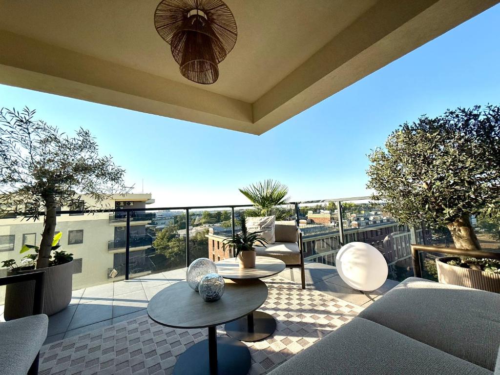 a living room with a view of a balcony at Louise Luxury - free parking in Nyíregyháza