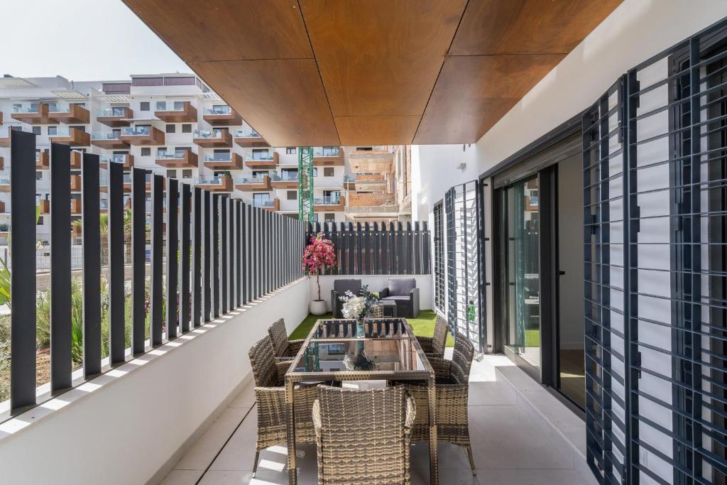 a balcony with a table and chairs on a building at Adhara lll in Torre del Mar