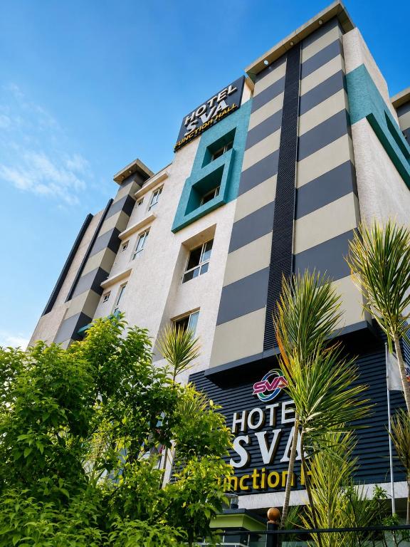a hotel with a sign in front of a building at Hotel SVA in Visakhapatnam