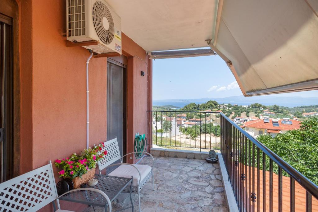 a balcony with a table and chairs on a building at Halkidiki Sunhouse in Paliouri