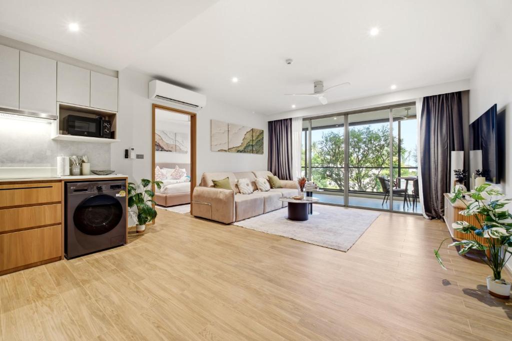 a living room with a couch and a table at Seashore Beach Residences by NLA in Bang Tao Beach