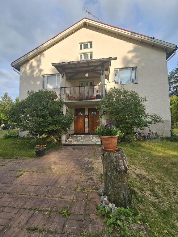 a house with a tree stump in front of it at Rönnypiha 