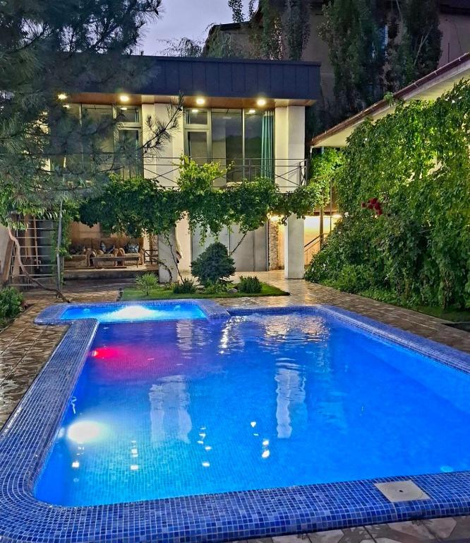 a swimming pool in the backyard of a house at Горный уют in Burchmulla