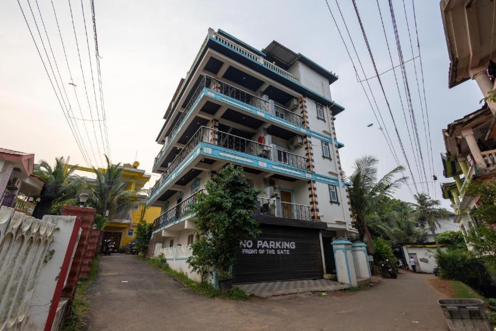 a tall building with a no parking sign on it at The Baga Pescador in Baga