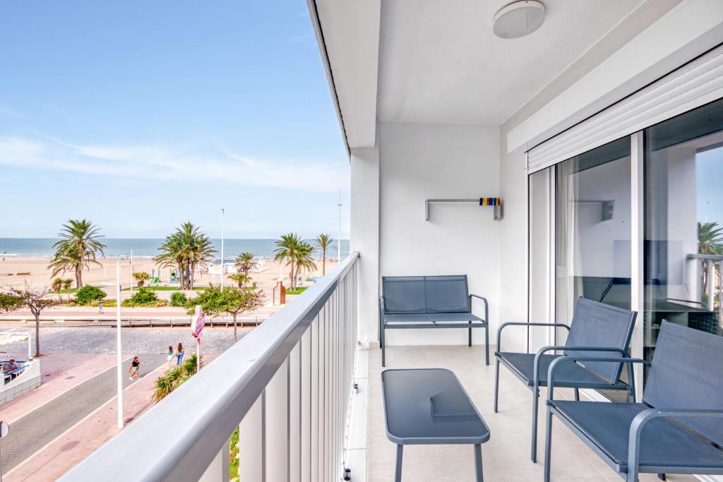 a balcony with chairs and a view of the beach at Bonaire in Gandía