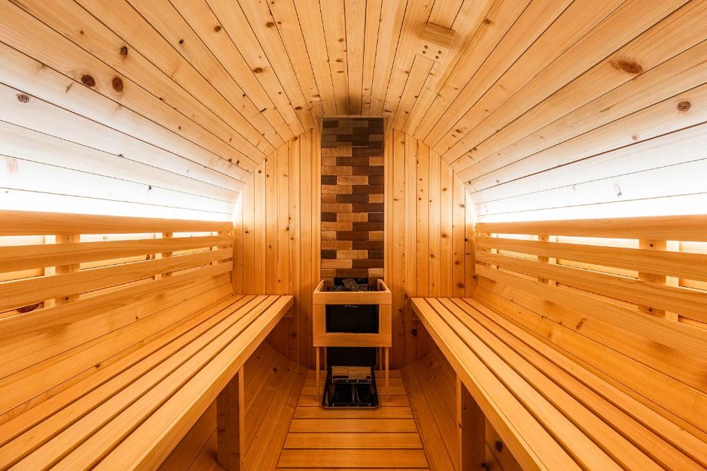 a wooden sauna with wooden walls and wooden floors at The Elysian Retreat in Otaru