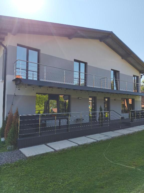 a large house with a balcony on top of it at Котедж у Русина in Pilipets