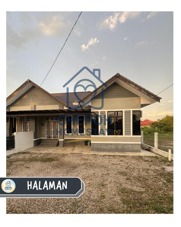 a house with a sign on top of it at Chepoh Homestay Pasir Mas in Pasir Mas