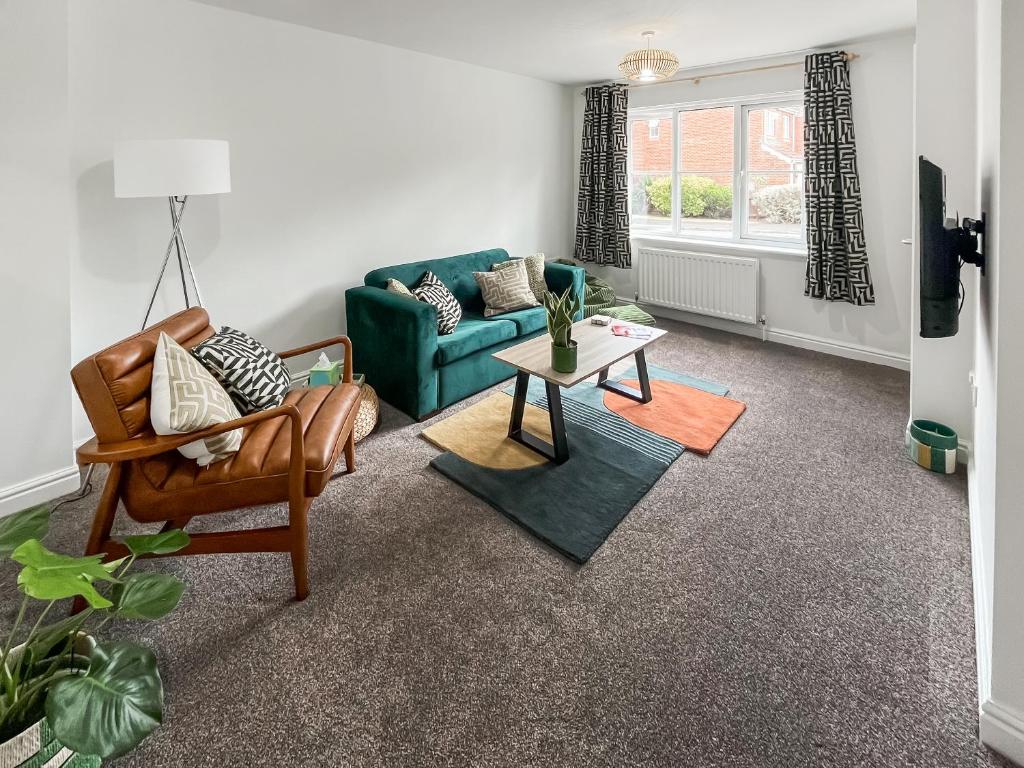 a living room with a couch and a table at Ashby Meadows in Spilsby